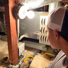 IV HVAC/R technician servicing a home furnace